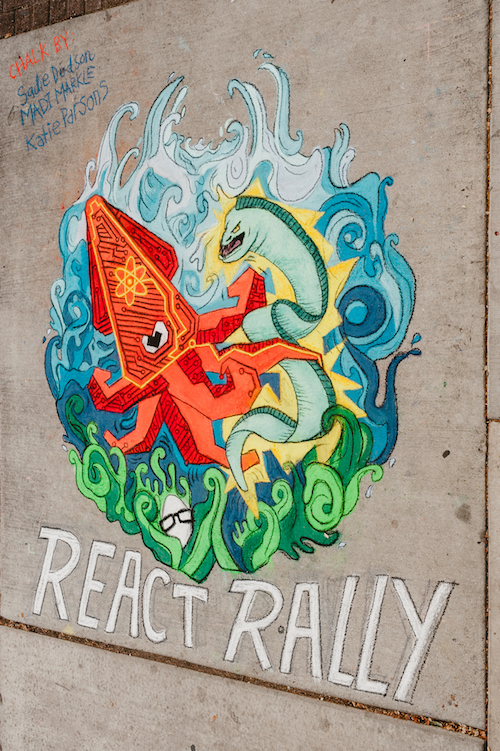 Chalk artists drawing the React Rally and Egghead.io
logos